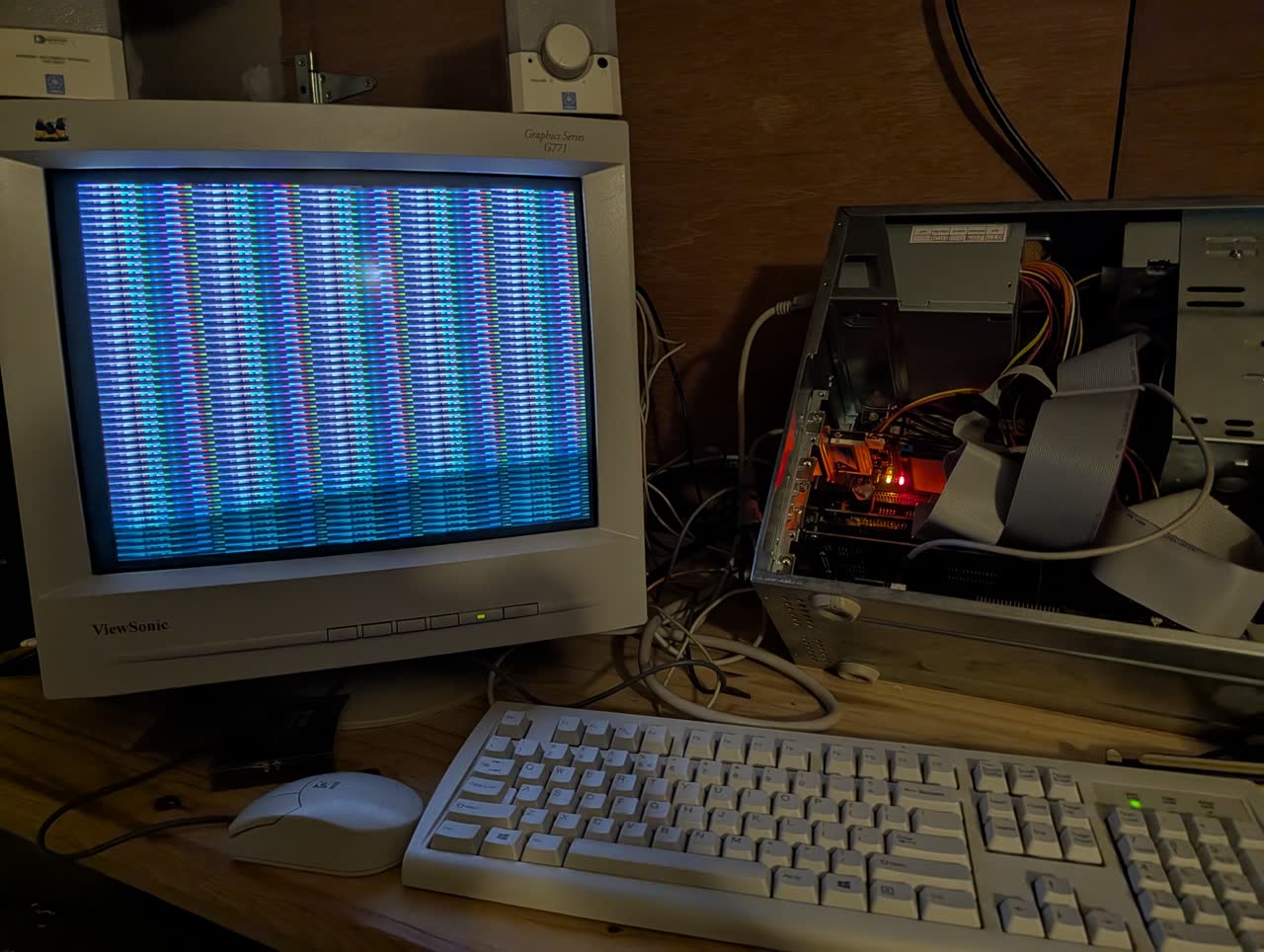 Photograph: 486 CRT monitor showing horizontal bands of blue, green, and red pixels during the bench_video mode 13h measurement.